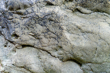 Close up of ancient rocks on Red Island containing minerals and metals