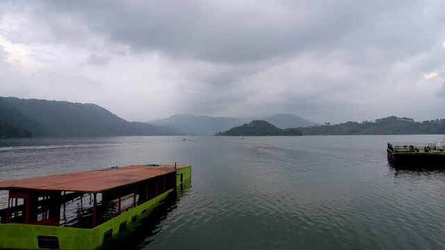 Back view of a speed boat with tourist at Umiam Lake Borapani Meghalaya with blue hills in the background 14