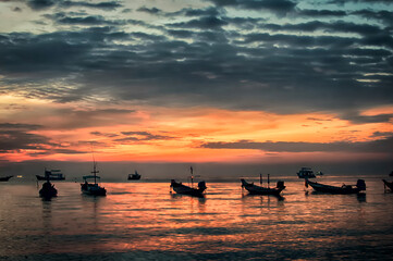 Traditional Thai boats near the beach at sunset time
