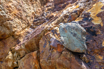 Close up of ancient rocks on Red Island containing minerals and metals