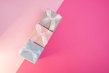 Stylish gift boxes with bow on color background. Valentines day gift for him. Corporate gift concept or birthday. Christmas background