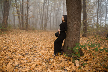 Enigmatic Woman in a Mysterious Autumn Forest