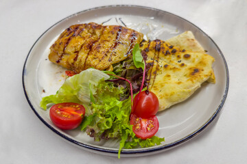 Roasted boneless chicken thigh with pita and fresh vegetables