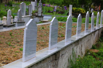 A Muslim cemetery prepared for a large family. A newly installed, clean, uninscribed tombstone. marble