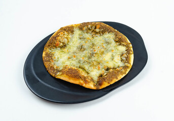 Manakeesh, arabic pizza, flat bread topped with zaatar spices close up. Homemade mediterranean flat bread manakish for breakfast
