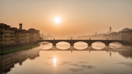 Fototapeta premium Serene Sunrise Over the Arno River in Florence, Showcasing the Misty Morning Light and the Architectural Beauty of the Italian Cityscape