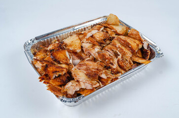 Close up of chicken shawarma meal with lettuce, tomato and onion on white background.
