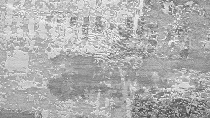 A grey wall with a lot of scratches and marks. The wall appears to be old and worn down