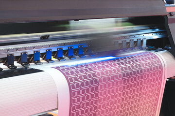 A printer is printing a colorful design on a piece of paper. The design features a series of...