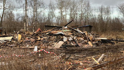 Ruins of a Collapsed Wooden House with Construction Debris and Wreckage, Post-Demolition Scene