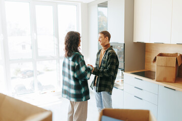 Joyful moment captured couple hugs in their new apartment filled with boxes