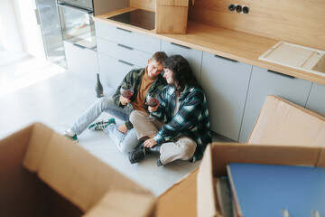 Young Family Discusses Renovation Plans While Enjoying Wine in Their Apartment