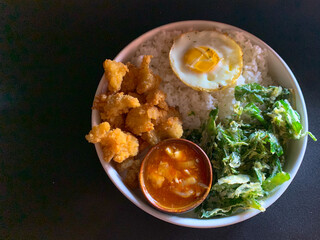 Fried chicken dish, crispy spinach, fried egg, combined with Singapore sauce. rice bowl, breakfast, healthy food