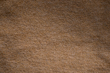 Rustic brown woolen knit fabric texture with subtle variations