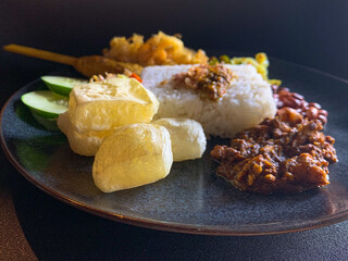 The charm of the deliciousness of Balinese, Indonesian specialties, namely mixed rice or Nasi Campur.