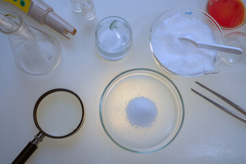 A scientist analyzes sports nutritional supplements. Measures the concentration of chemicals and checks the quality of the powder.