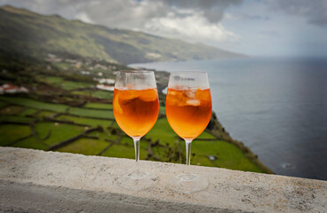 Two glasses of Aperol Spritz agaist the ocean view