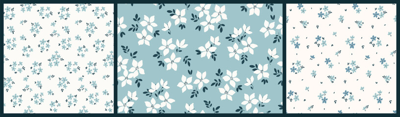 Obraz premium Seamless floral pattern, liberty ditsy print, abstract ornament in gentle spring motif. Simple cute botanical design: small hand drawn white flowers, tiny leaves, bouquets on blue. Vector illustration