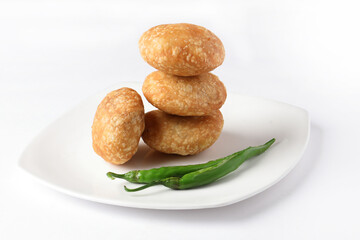 Kachori, green chilly, kachori is a spicy snack from India also called  kachauri and kachodi. Favorite Tea time snacks
served in a ceramic plate
