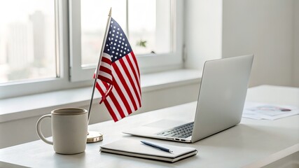 A desk with a laptop, a mug, and a flag