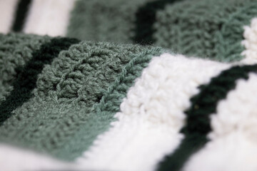 close-up of grandma's retro zigzag striped blanket, in white, sage green and hunter green,...