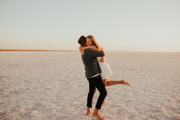 pink Lemurian lake, romantic photoshoot of young couple in love