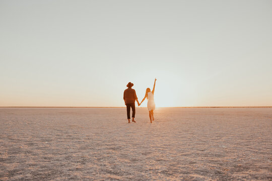 pink Lemurian lake, romantic photoshoot of young couple in love