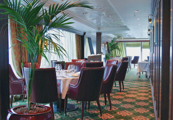 Formal and elegant ocean view dining room restaurant onboard luxury cruiseship or cruise ship liner...