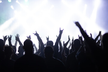 Crowd at concert and blurred stage lights.