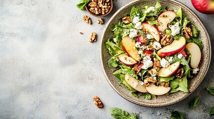 Fresh apple walnut salad on rustic background
