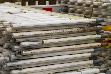 Stack of white plastic mobile traffic barriers creating a protective fence