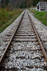 Railroad tracks disappearing into the mountainous landscape. Train lines outdoors. Public transportation