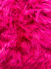 A pink fur texture with a shiny appearance