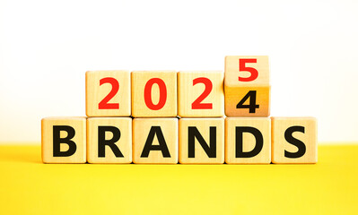 Planning 2025 brands new year symbol. Concept words 2024 Brands to 2025 Brands on beautiful wooden blocks. Beautiful yellow table white background. Business 2025 brands new year concept. Copy space.