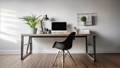 A modern home office with a black desk chair, a desktop computer, and a houseplant.