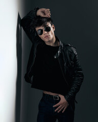 cool fashin model with sunglasses posing in a confident way