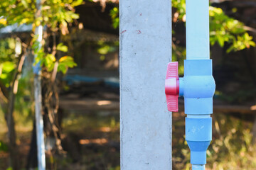 Close-up of a red water shut-off valve.