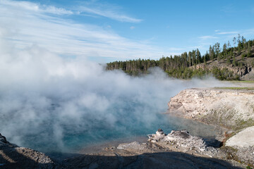 Steam rises from the Excelsior Geyser within Yellowstone Park in Montana
