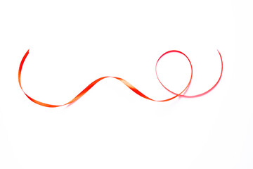 A vibrant red ribbon curled on a white background