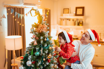 merry christmas, family, present, christmas, celebrate, christmas present, parents, celebration, enjoying, enjoyment. A man and a child are decorating a Christmas tree together.