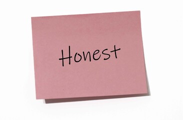 Pink Sticky Note with "Honest" Written in Black Handwriting Font on a White Background, Representing Values of Integrity and Transparency in Personal and Professional Settings