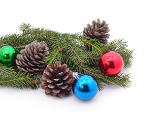Christmas tree branch with decorations and cones.