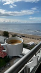 Morning Coffee with Scenic Beach View Under Blue Sky