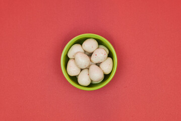 different shapes of gum with different flavors representing white Easter eggs with red spots.