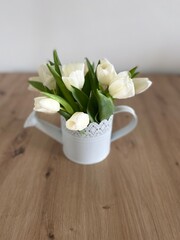 bouquet of white tulips in watering-can