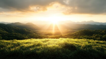 Obraz premium A beautiful sunrise casts a radiant glow across lush green valleys, with distant mountains in view, embodying hope, renewal, and the splendor of nature.