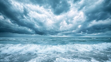 Rough ocean waves crash against the shore beneath dramatic, dark storm clouds, showcasing nature's power and raw beauty