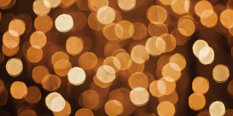 Golden Hour Bokeh: Warm, inviting, and subtly textured, this image features a captivating bokeh effect with amber and gold light orbs, perfect for backgrounds, overlays, and festive designs. 