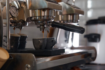 Closeup view on ceramic cup with pouring freshly brewed aroma coffee