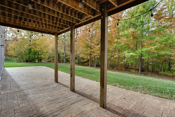 Tranquil Backyard Patio With Fall Foliage And Lights